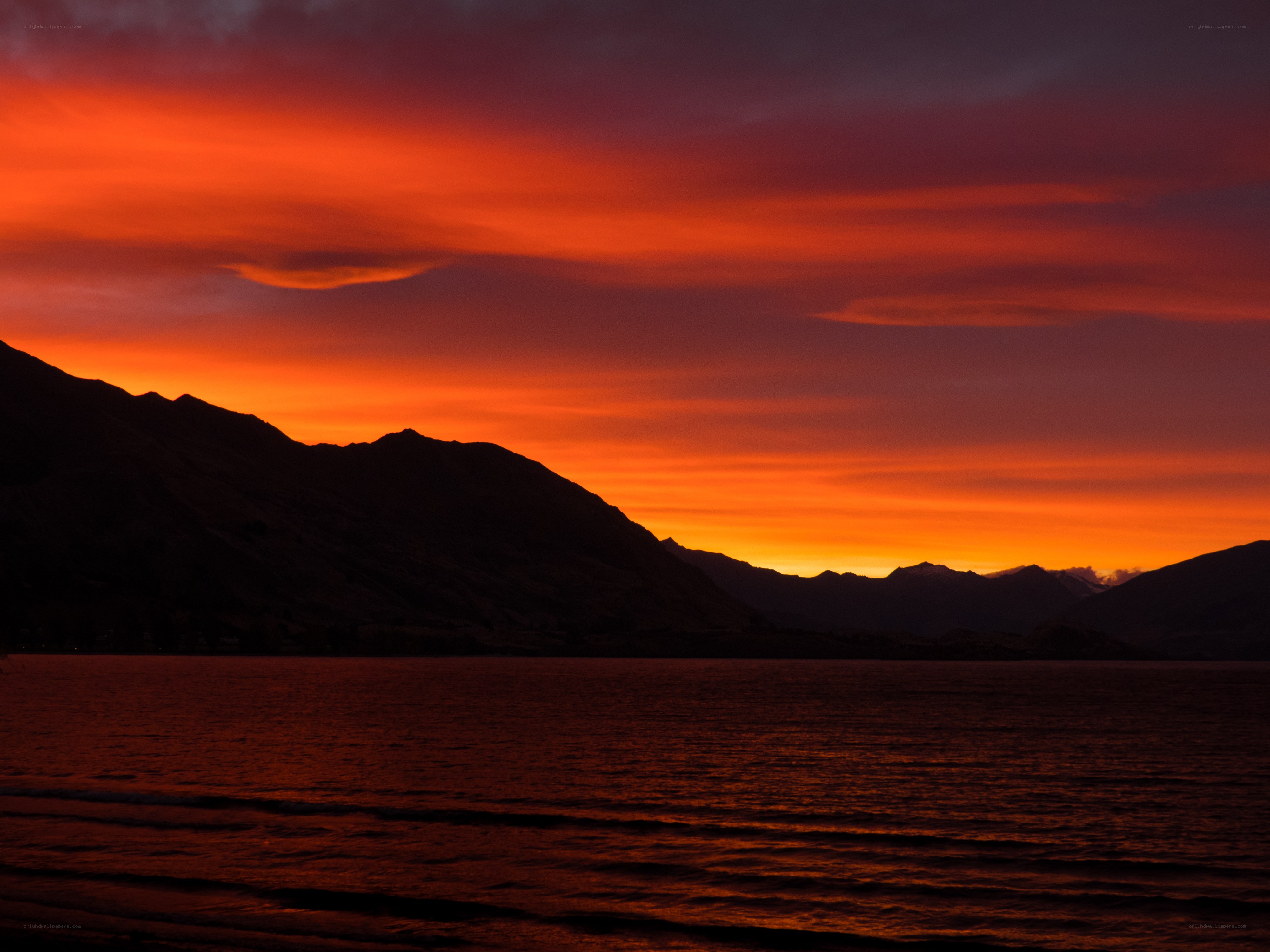 Vibrant sunset over mountain lake