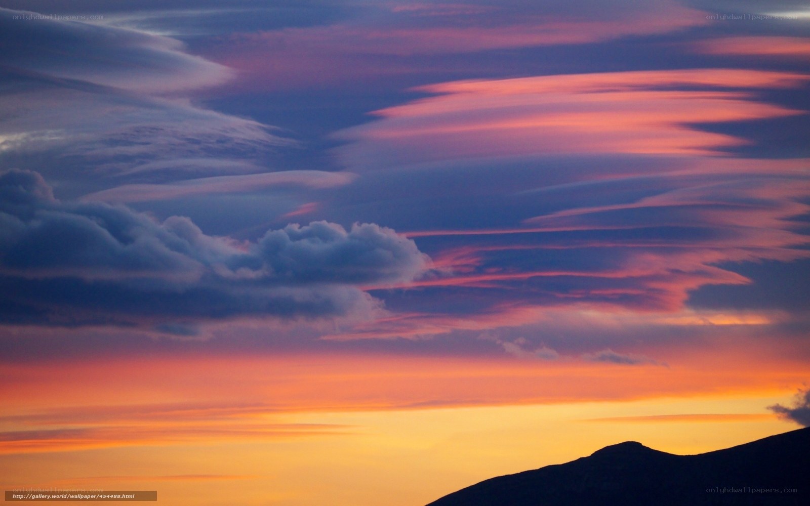 Vibrant sunset over mountain silhouette