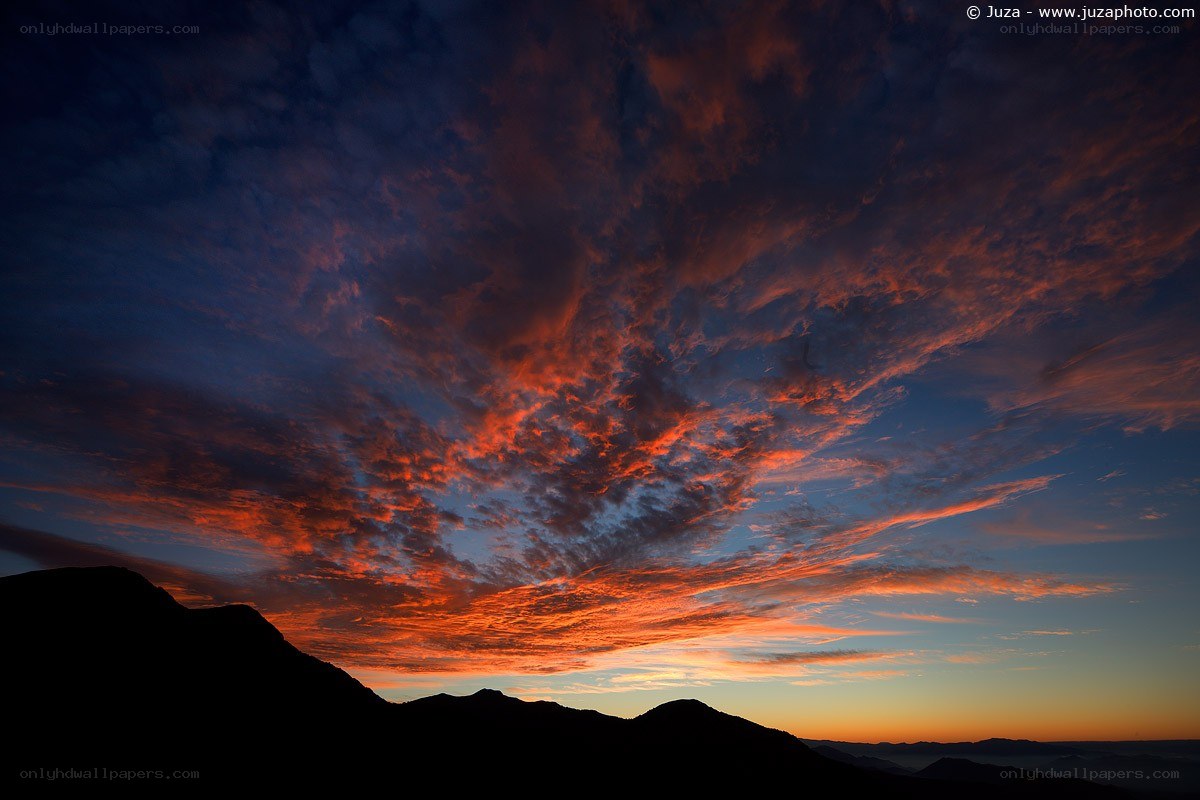 Vibrant sunset over mountain silhouettes