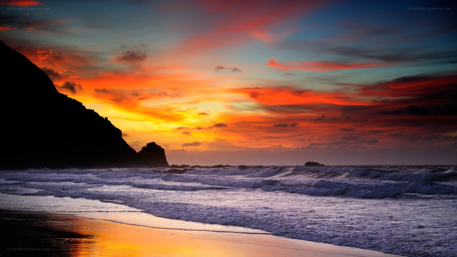 Vibrant sunset over rocky beach