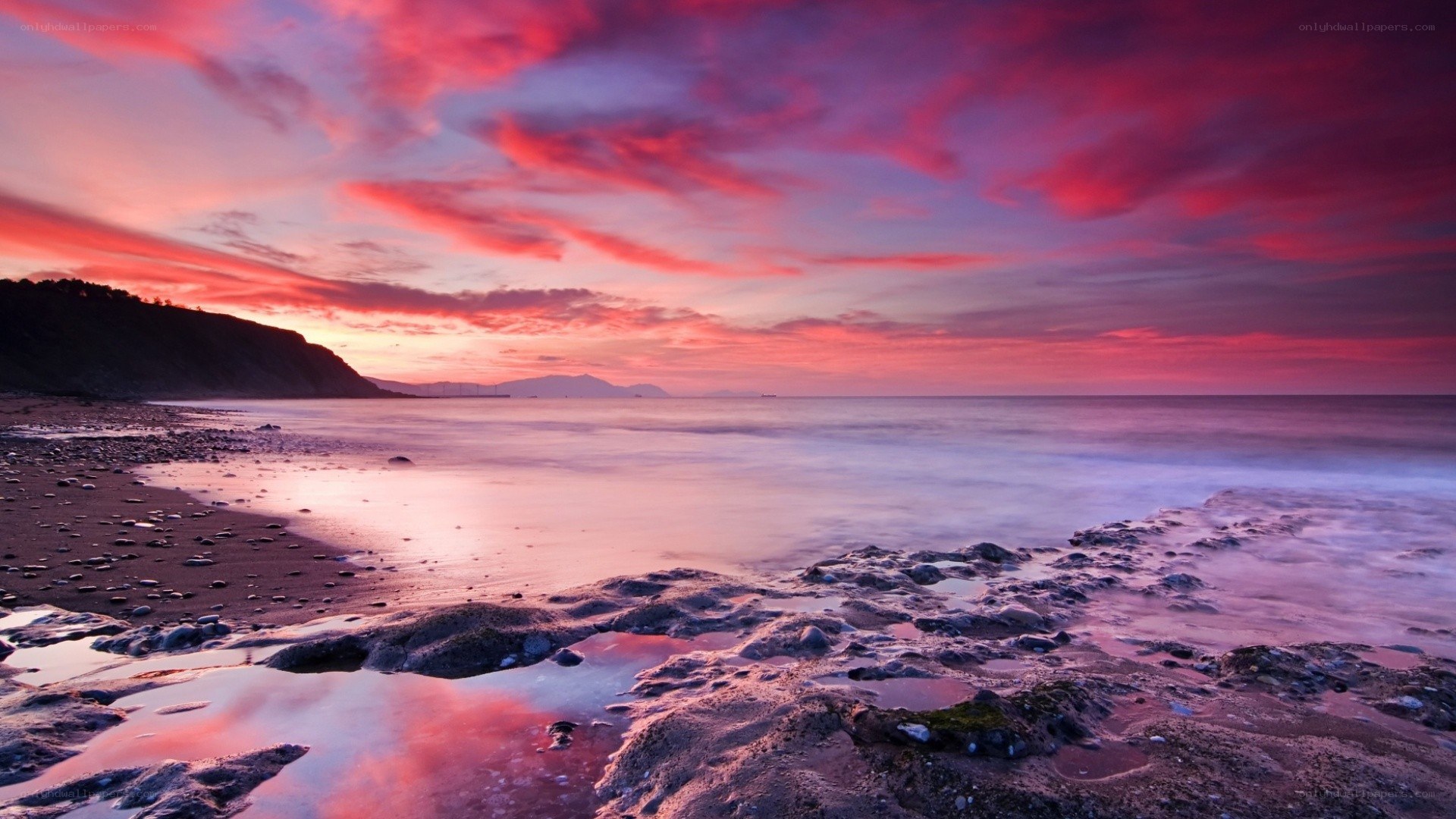 Vibrant sunset over rocky beach