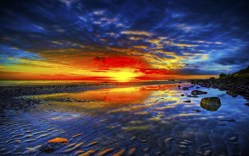 Vibrant sunset over rocky beach