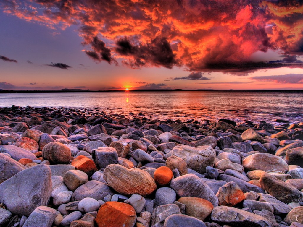 Vibrant sunset over rocky beach
