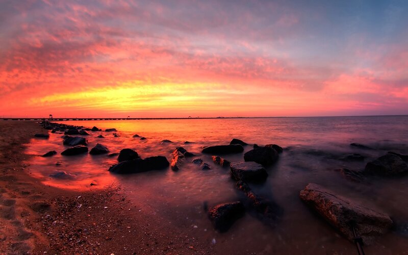 Vibrant sunset over rocky beach