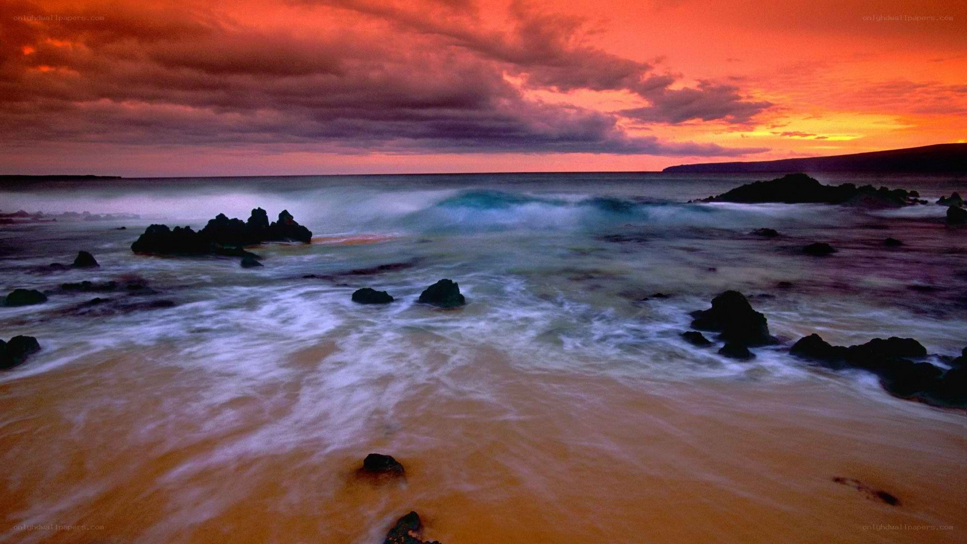 Vibrant sunset over rocky beach