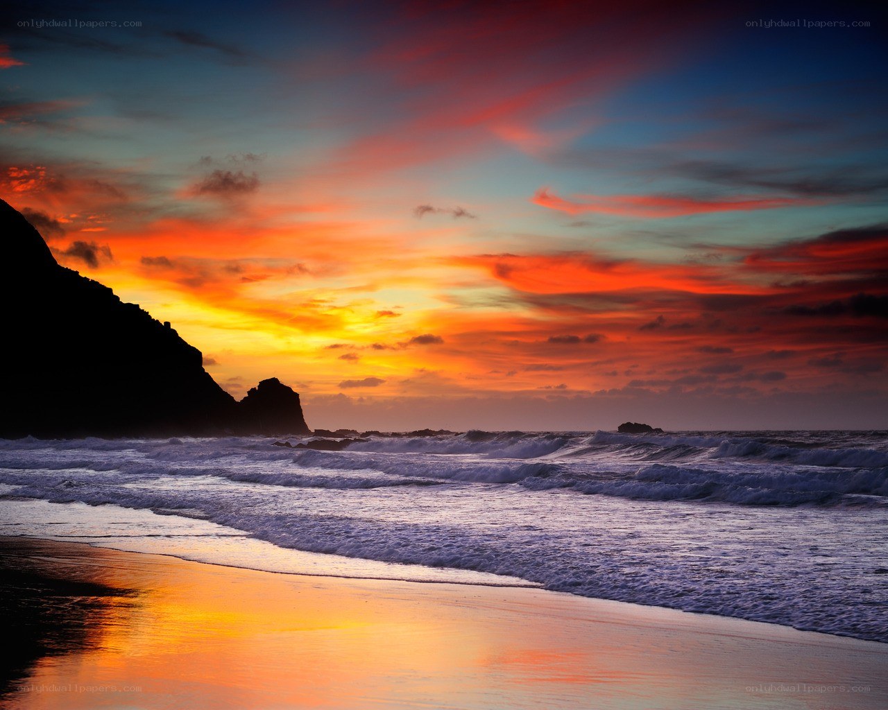 Vibrant sunset over rocky beach