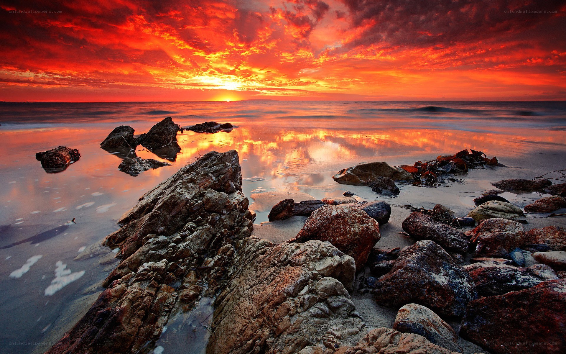 Vibrant sunset over rocky beach