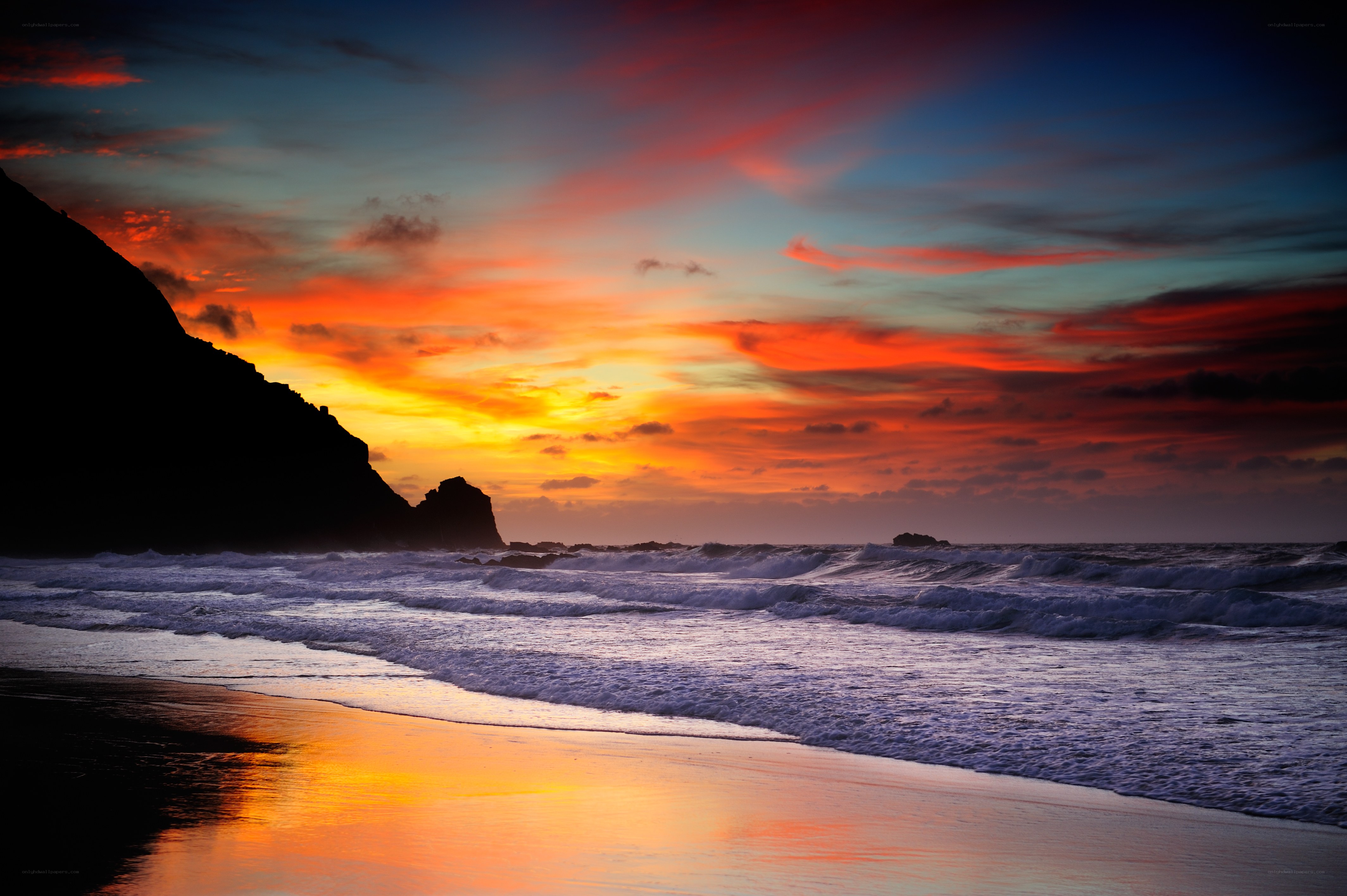 Vibrant sunset over rocky beach