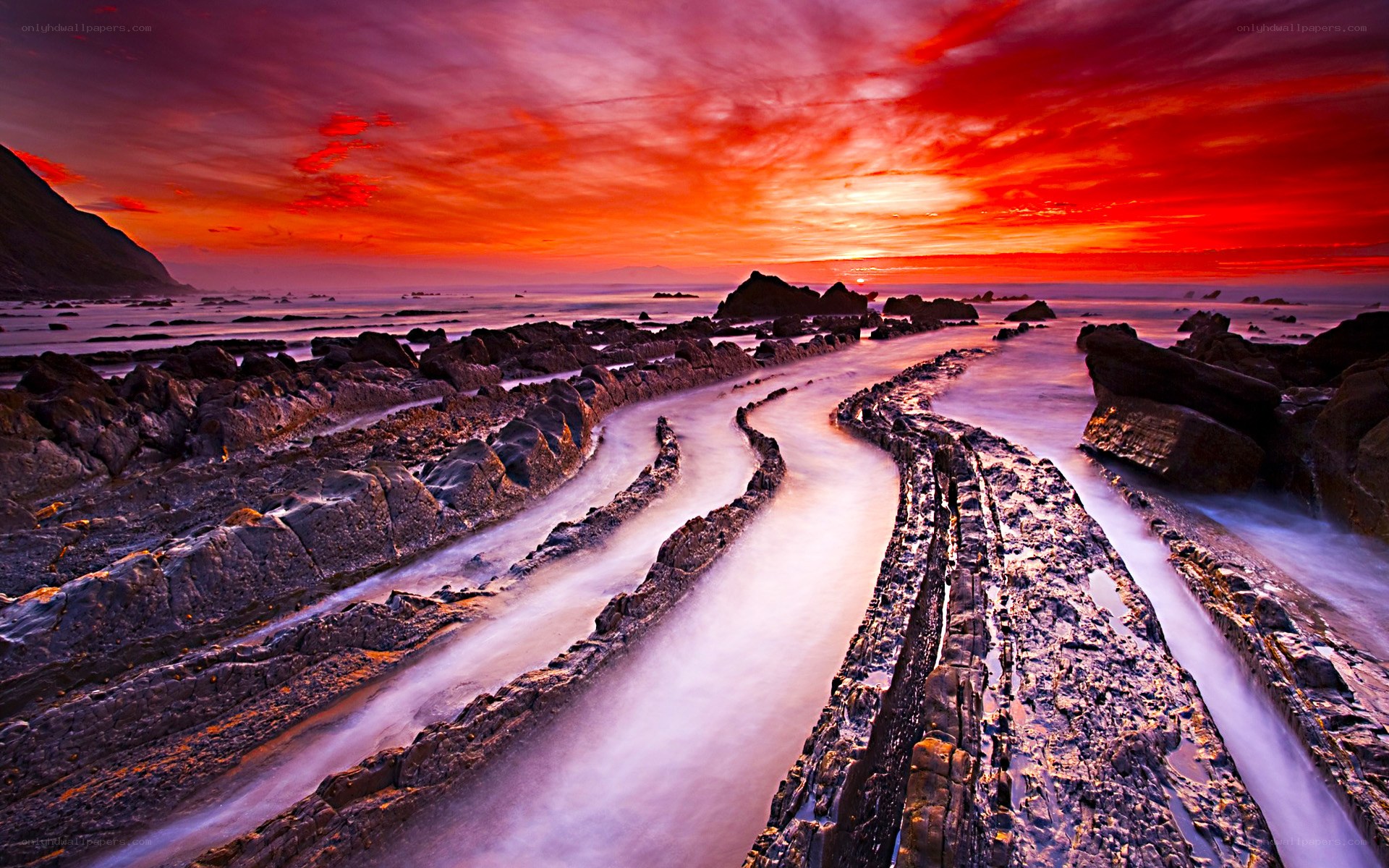 Vibrant sunset over rocky coastline