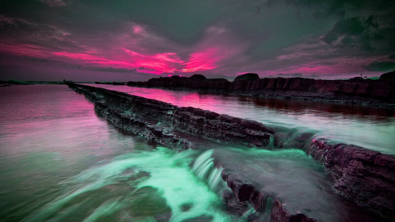 Vibrant sunset over rocky coastline