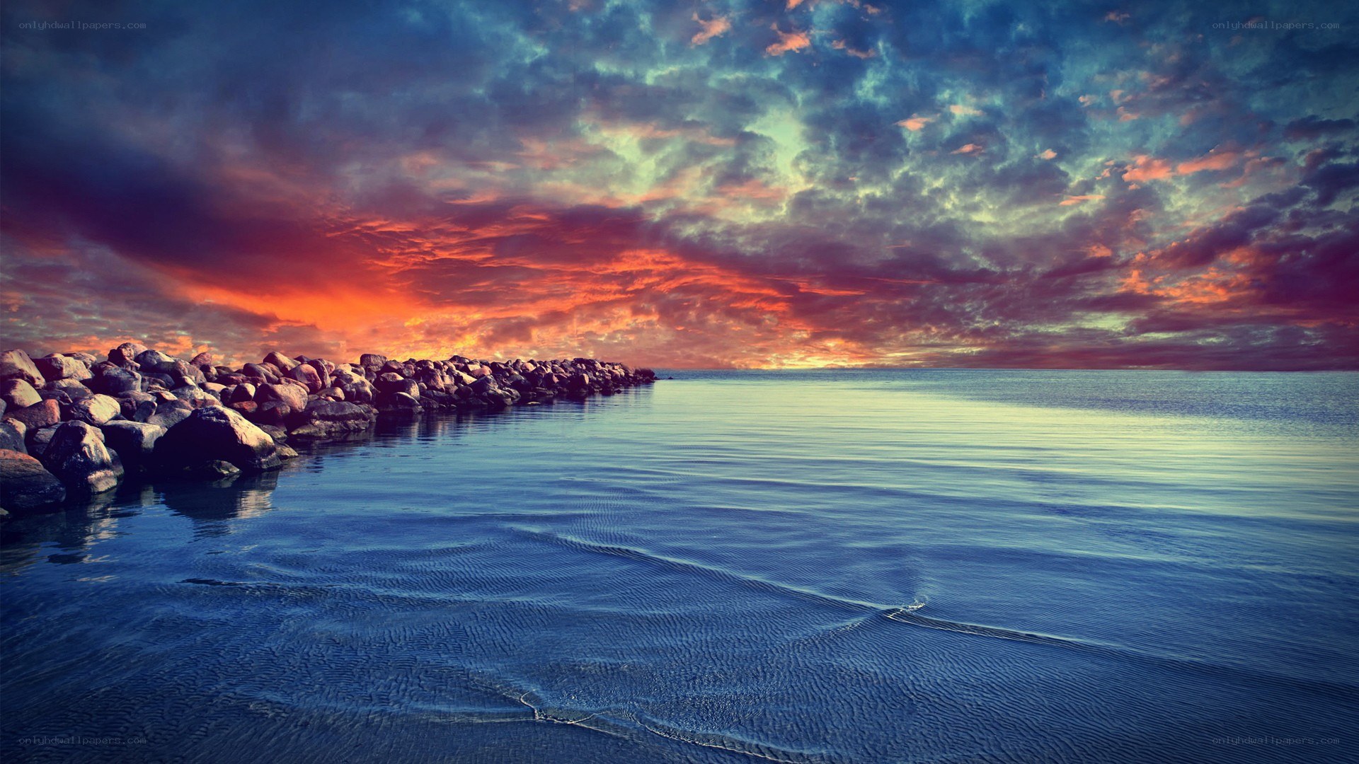 Vibrant sunset over rocky pier