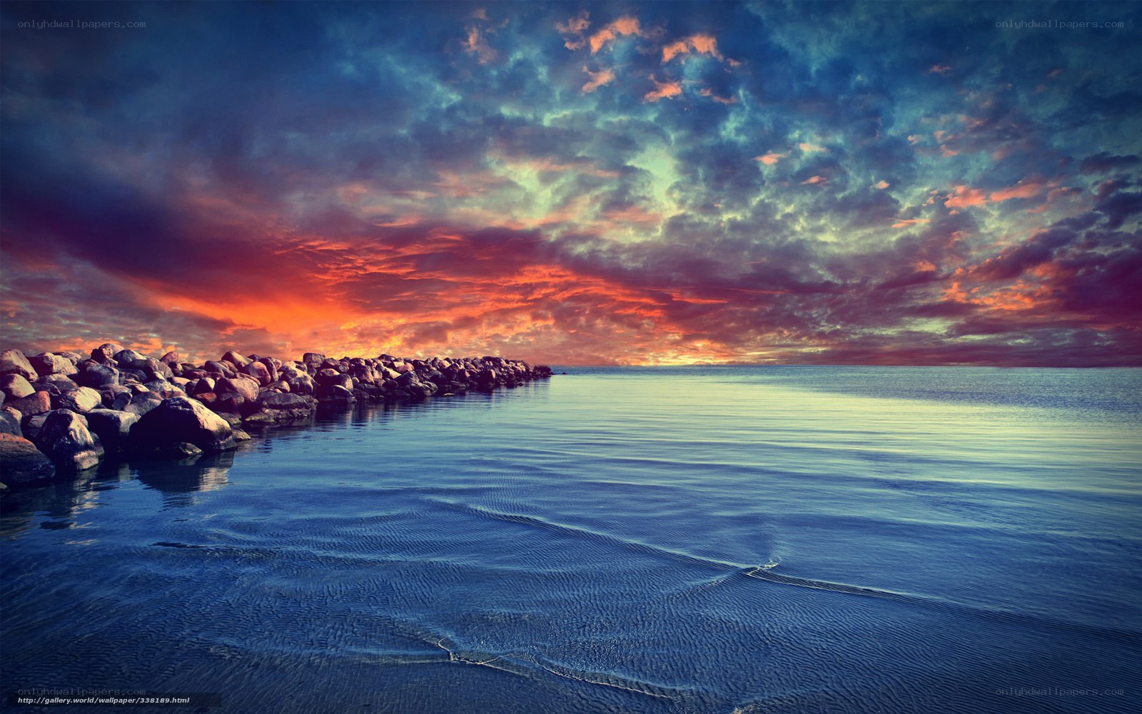 Vibrant sunset over rocky pier