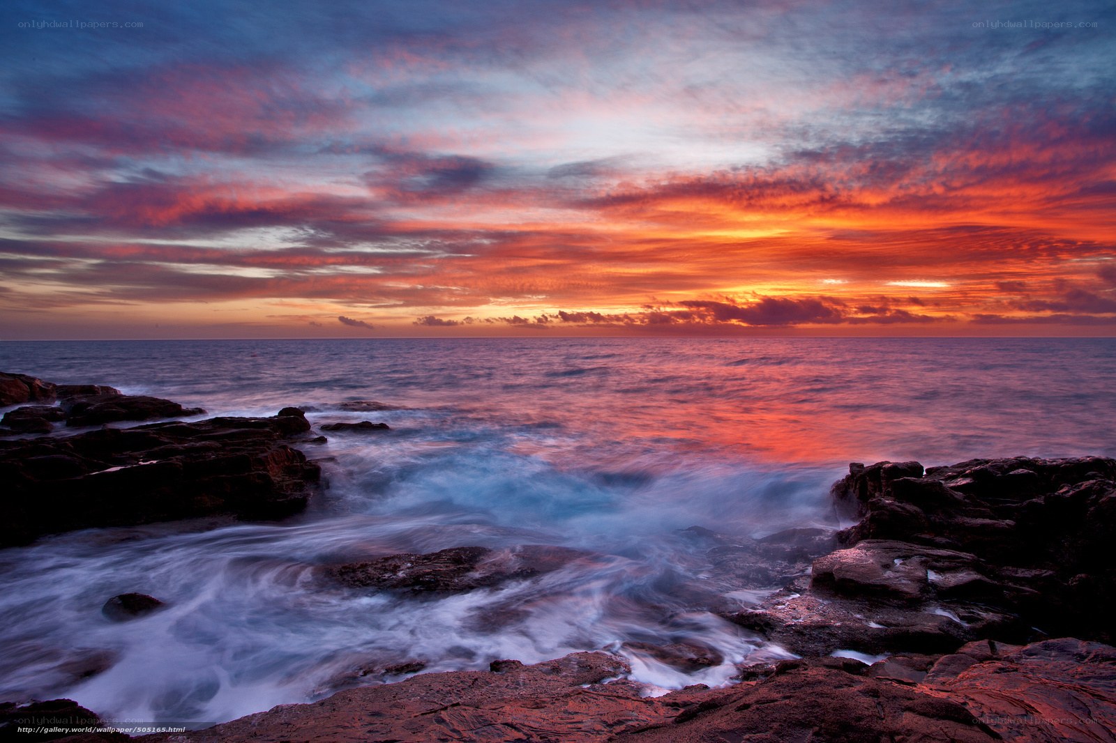 Vibrant sunset over rocky shore