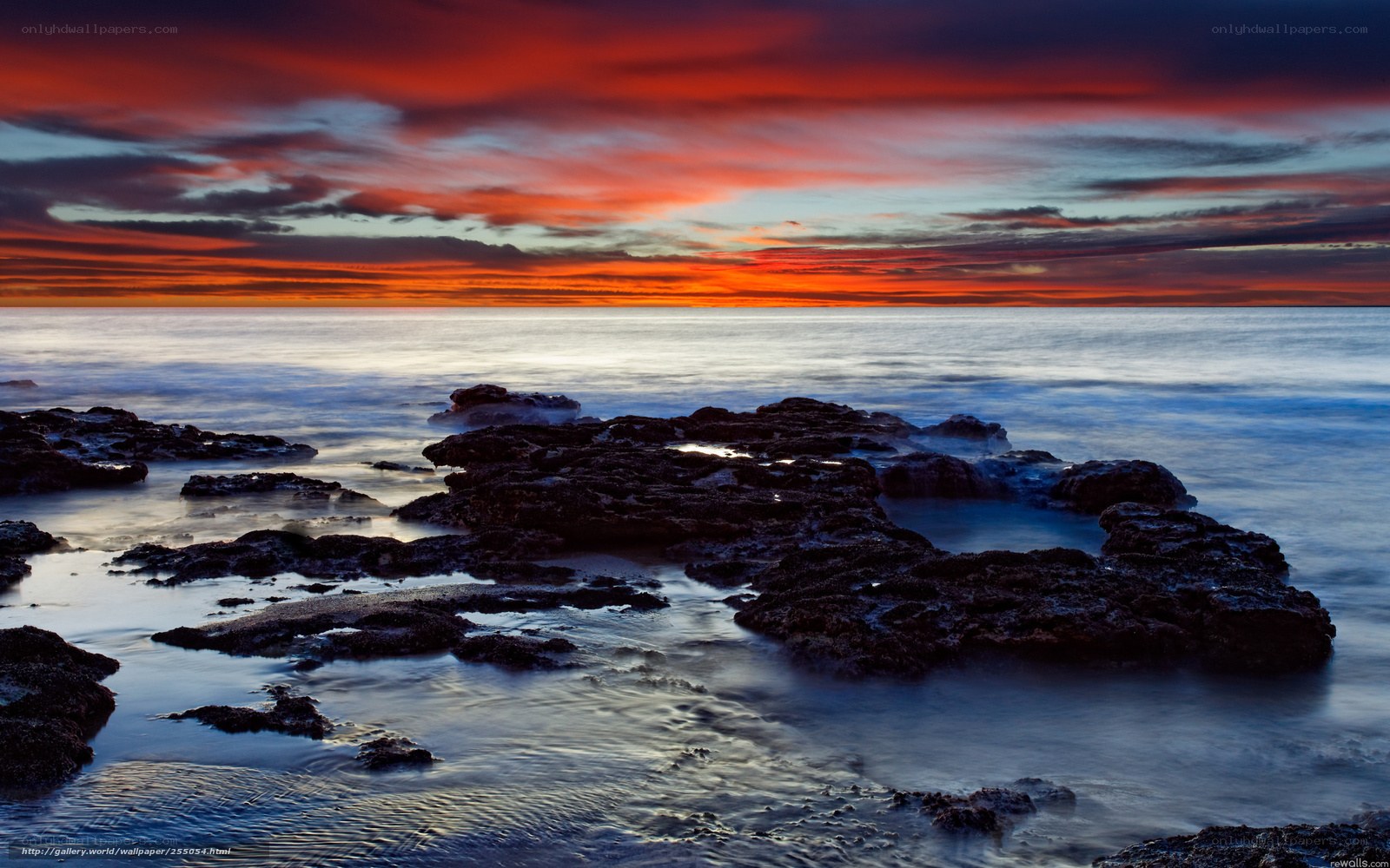 Vibrant sunset over rocky shore