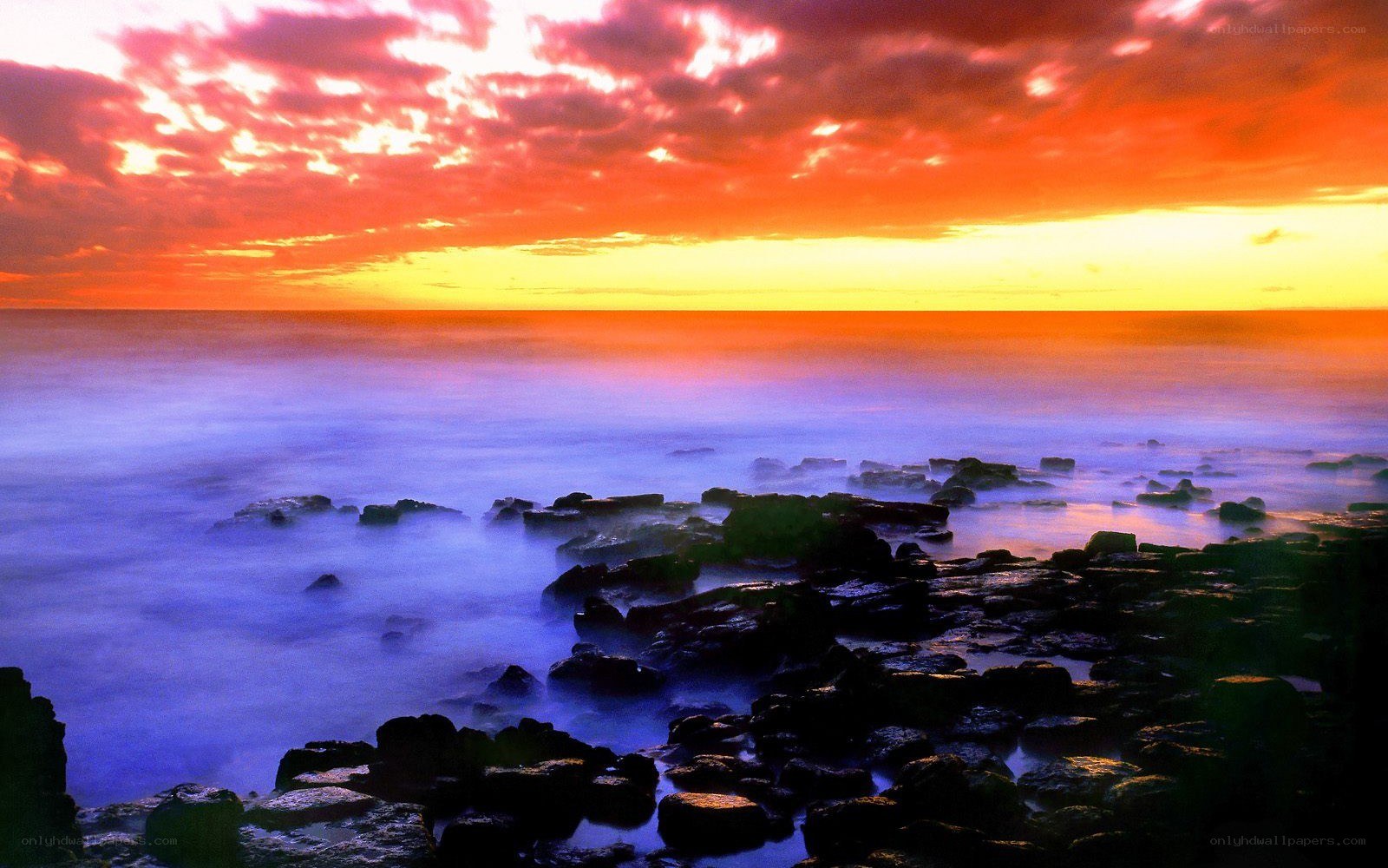 Vibrant sunset over rocky shore