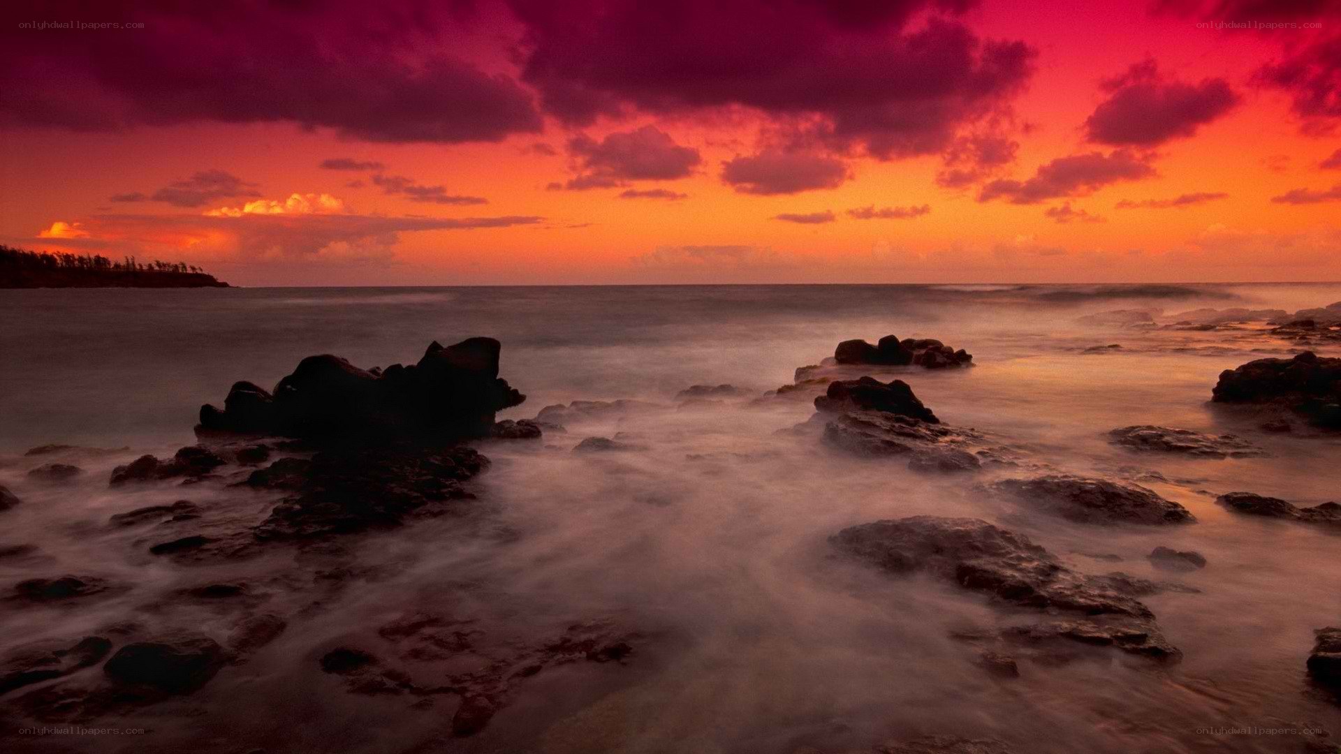 Vibrant sunset over rocky shore