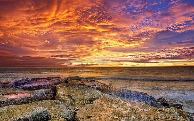 Vibrant sunset over rocky shore