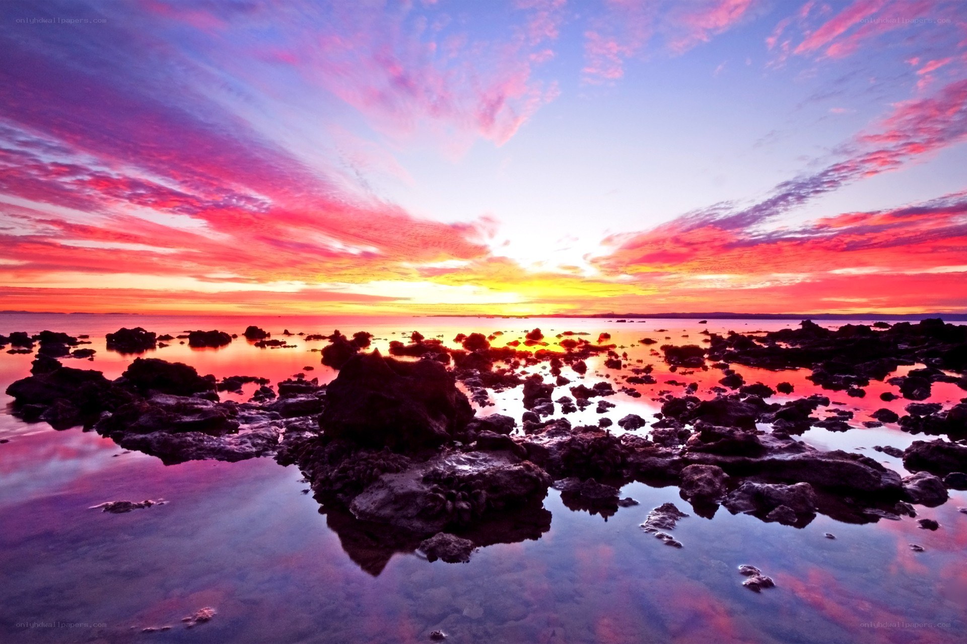 Vibrant sunset over rocky shore
