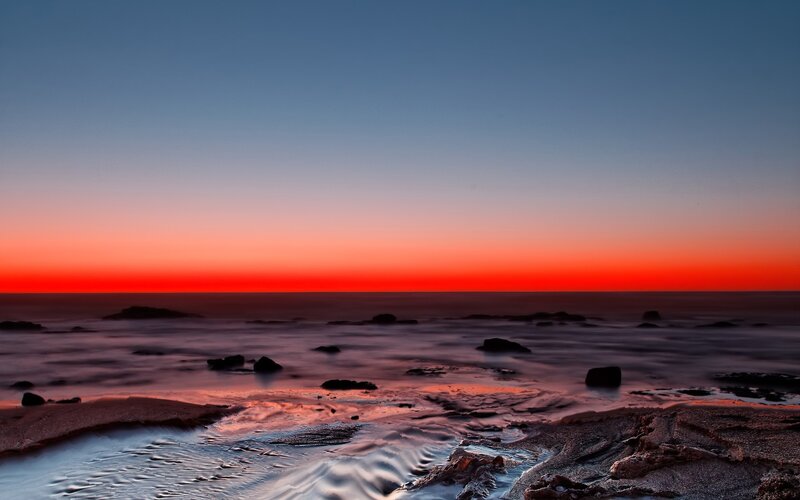 Vibrant sunset over rocky shore