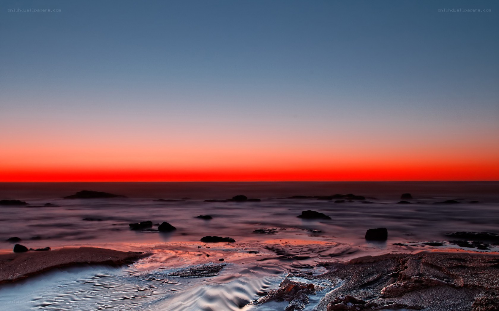 Vibrant sunset over rocky shore