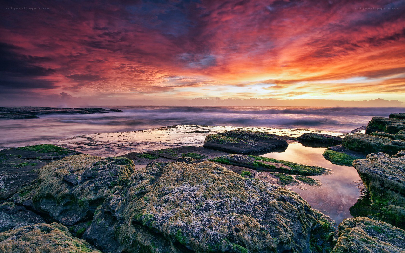 Vibrant sunset over rocky shore