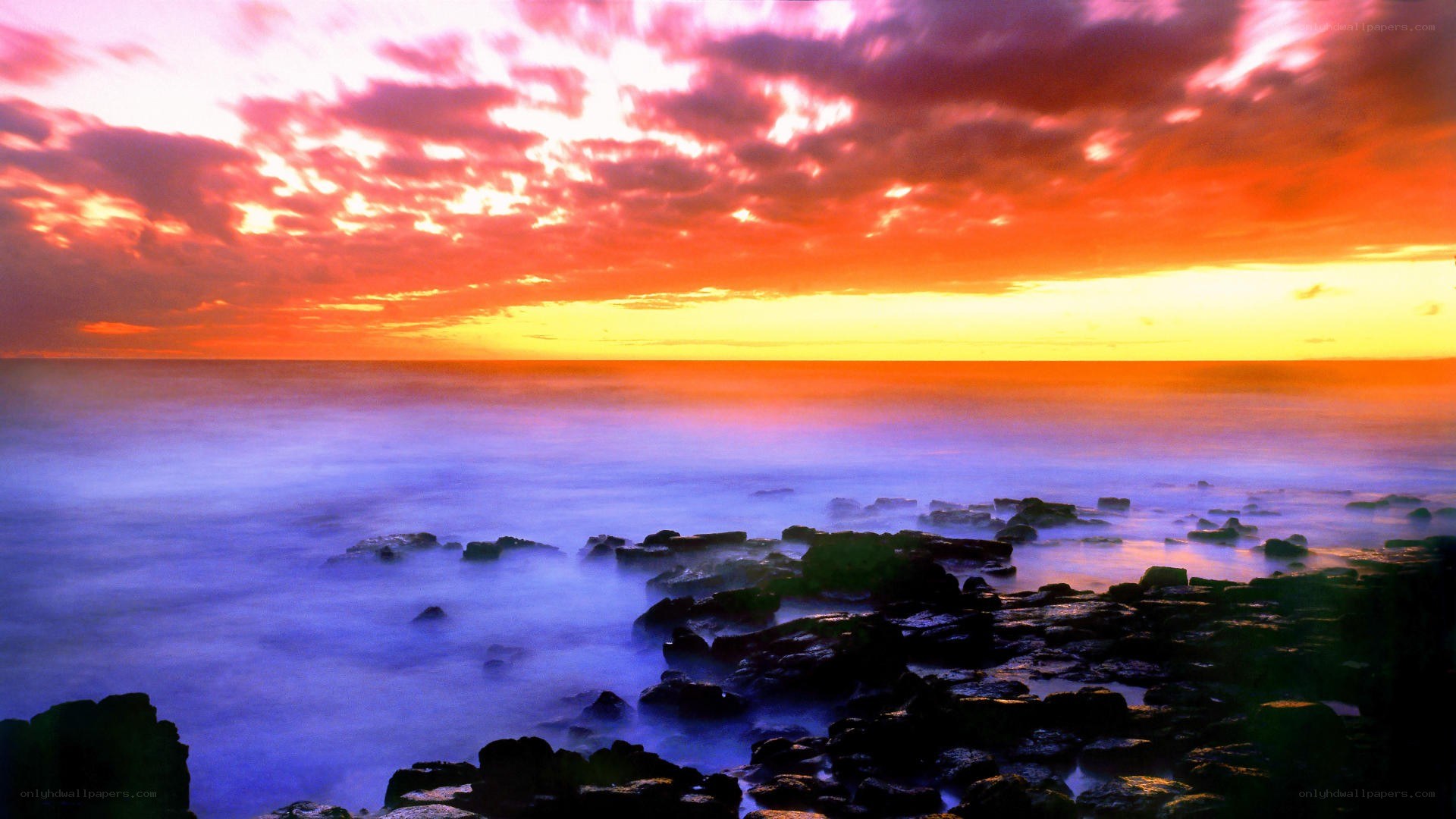 vibrant sunset over rocky shore