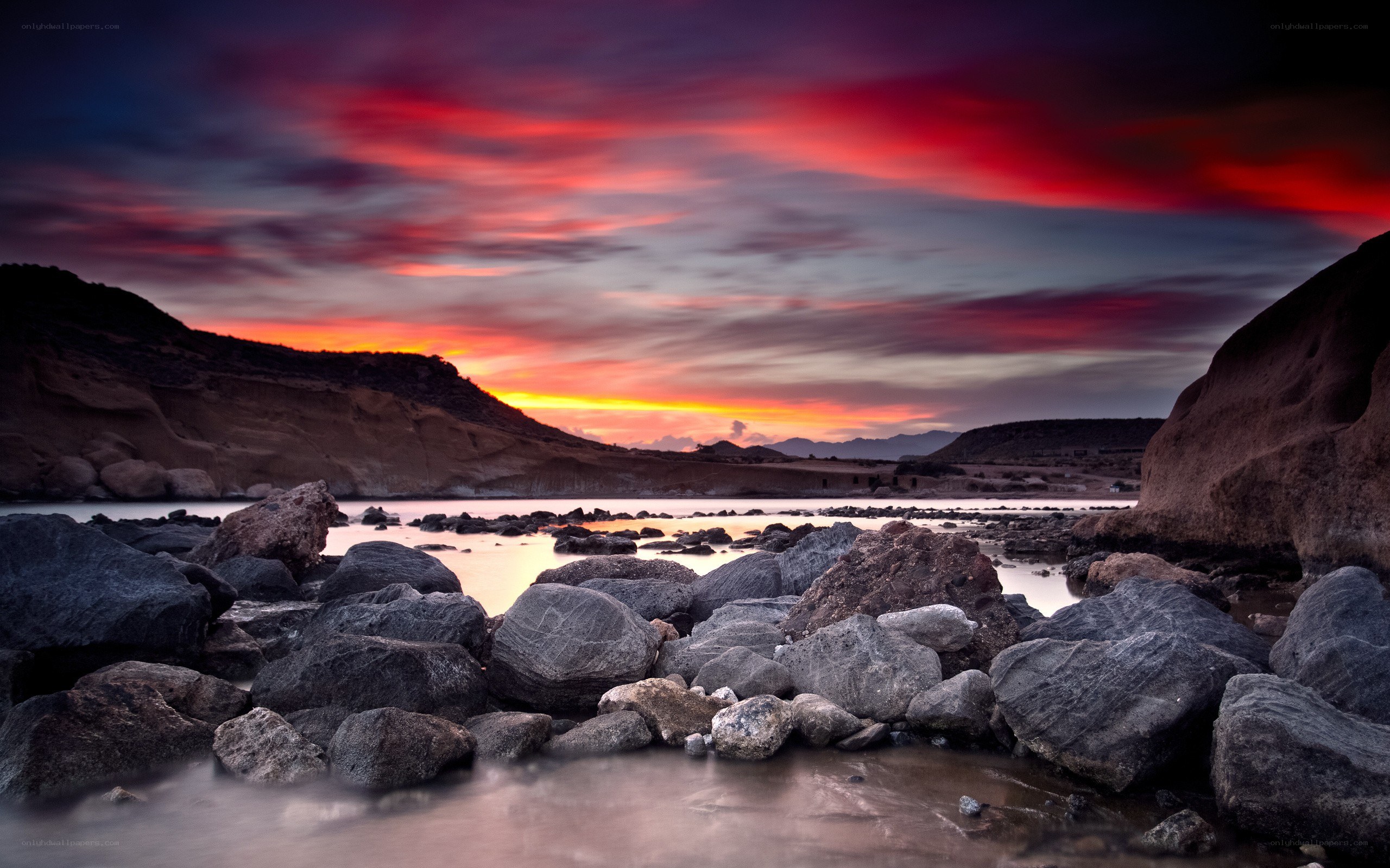 Vibrant sunset over rocky shore