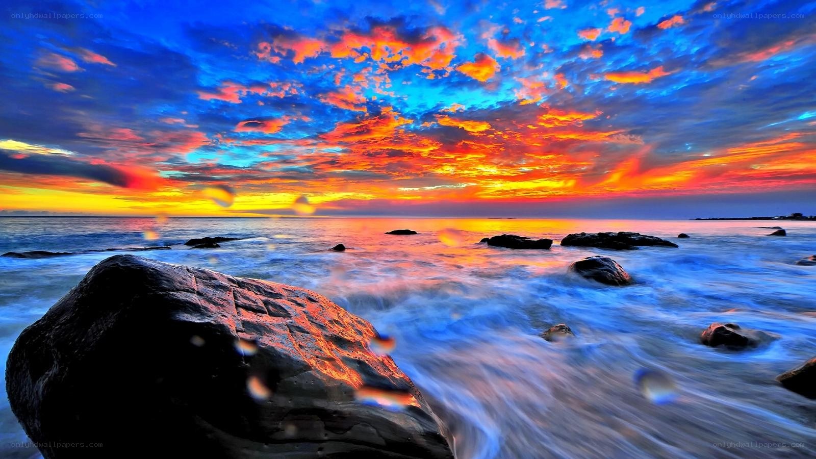 Vibrant sunset over rocky shore
