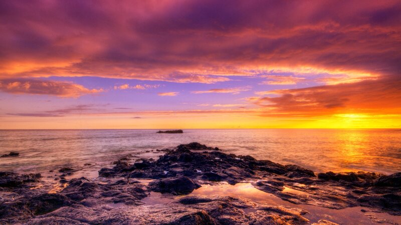 Vibrant sunset over rocky shore