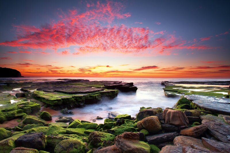 Vibrant sunset over rocky shore