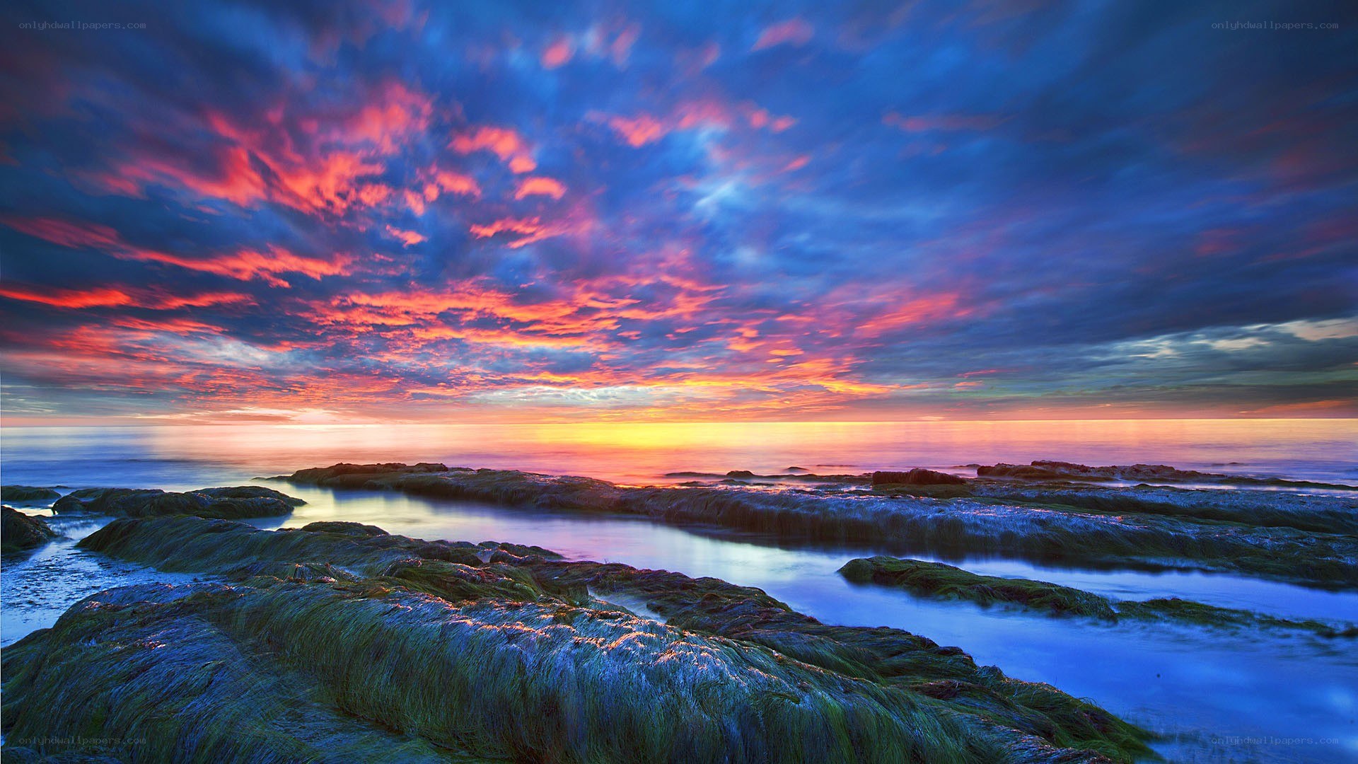 Vibrant sunset over rocky shore