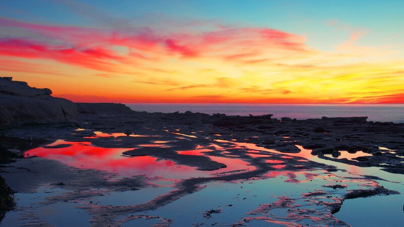 Vibrant sunset over rocky shore