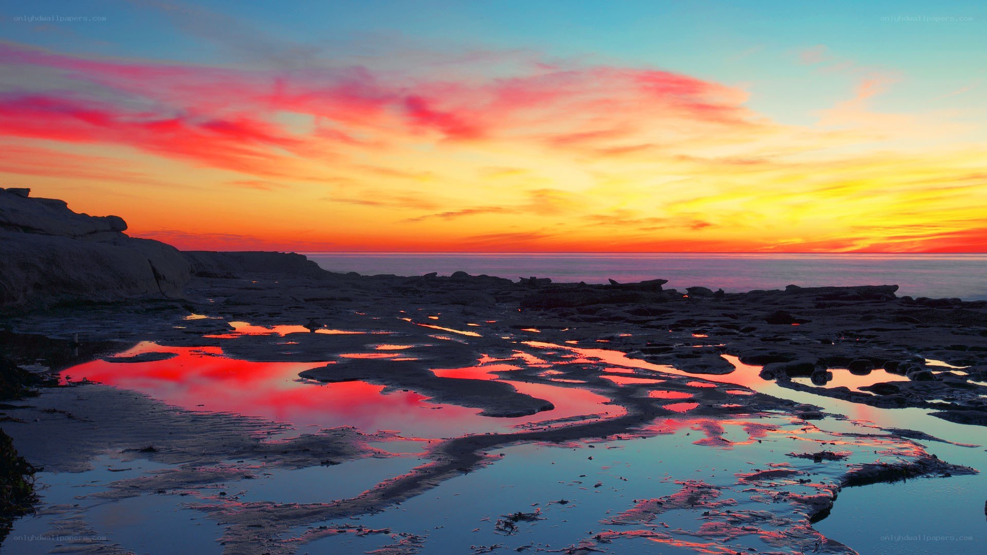 Vibrant sunset over rocky shore