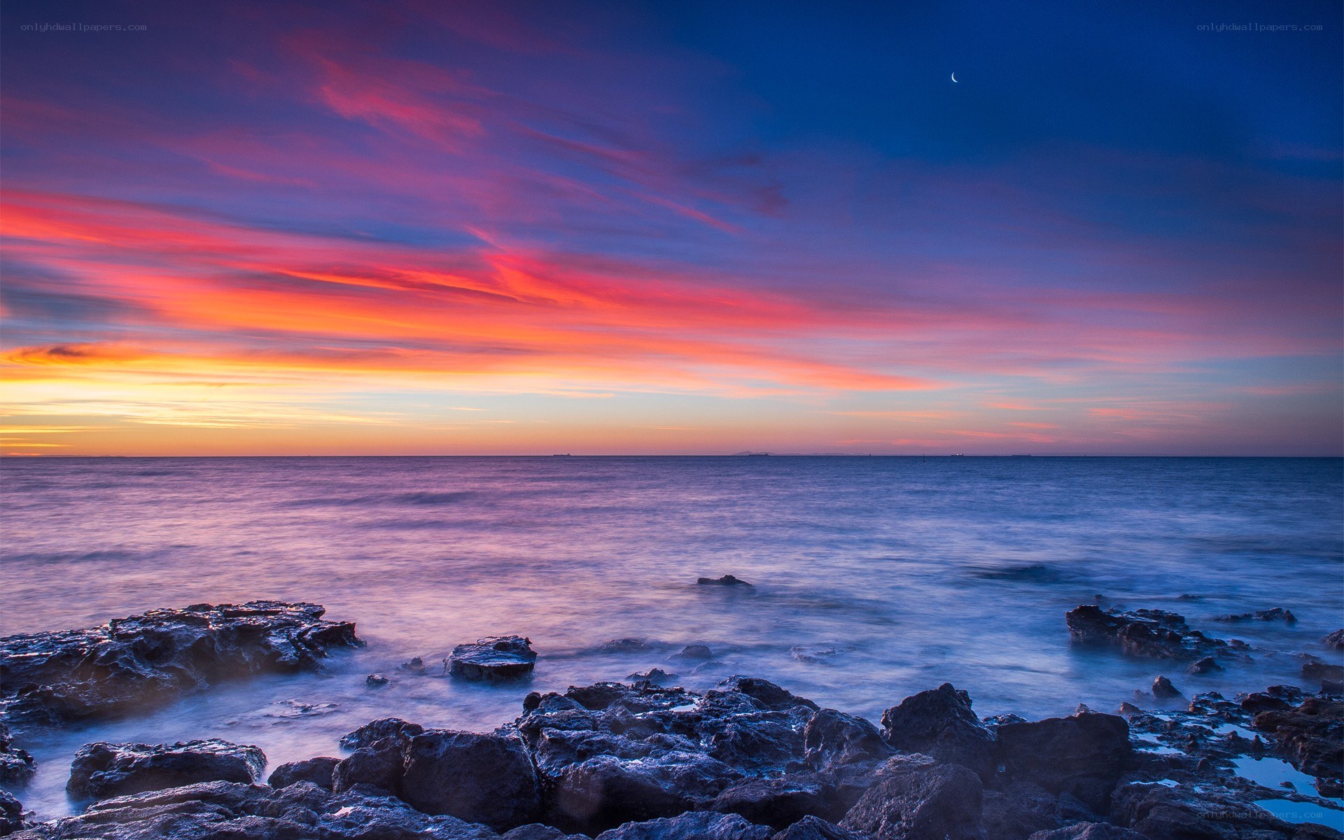 Vibrant sunset over rocky shore