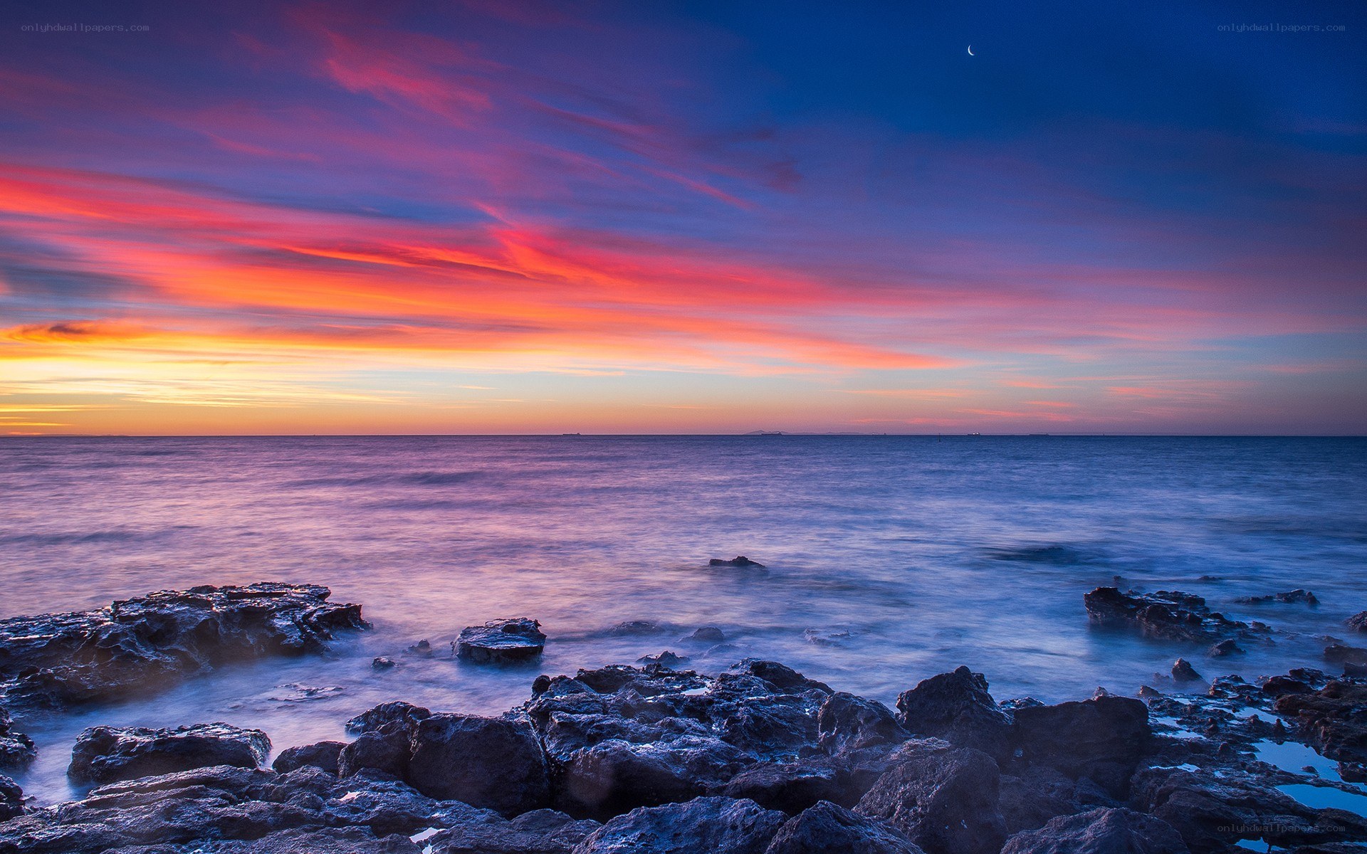 Vibrant sunset over rocky shore