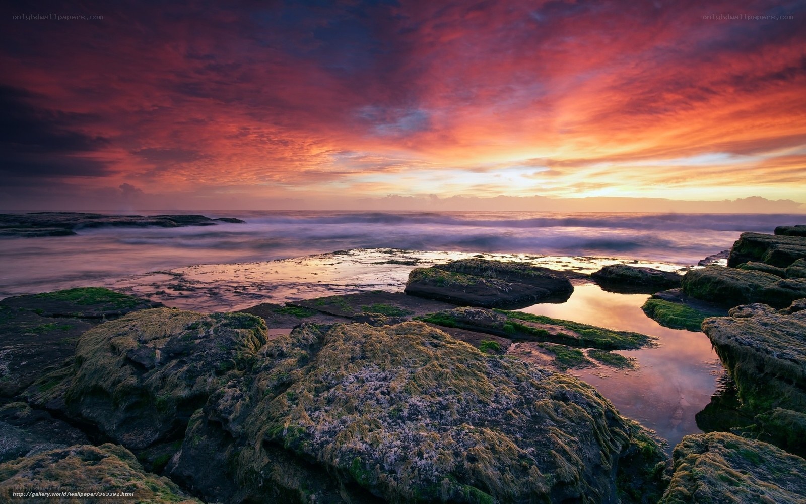 Vibrant sunset over rocky shore