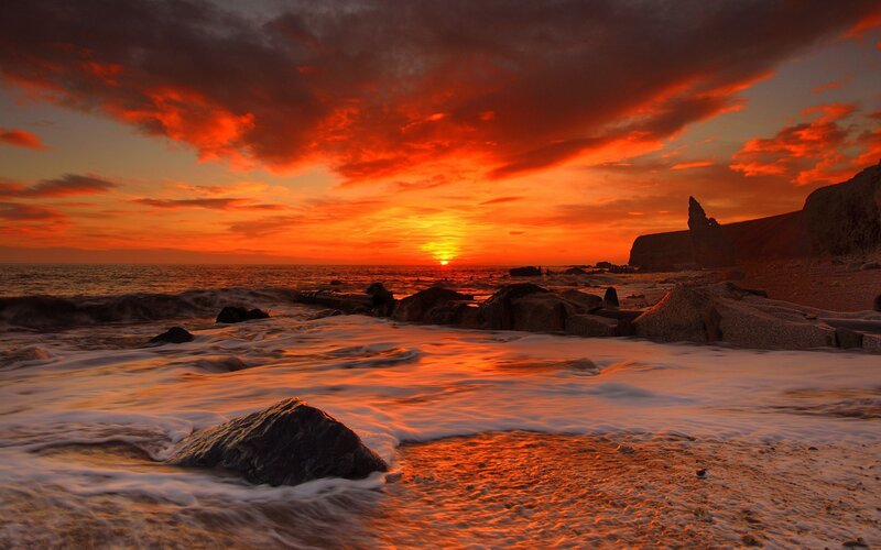 Vibrant sunset over rocky shore