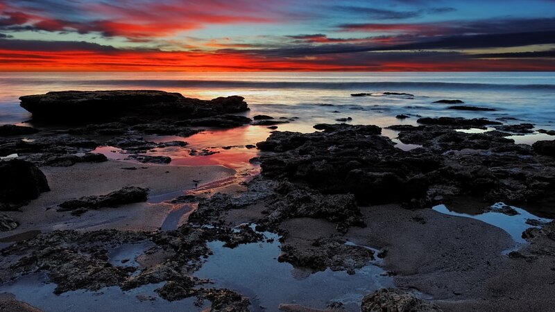 Vibrant sunset over rocky shore
