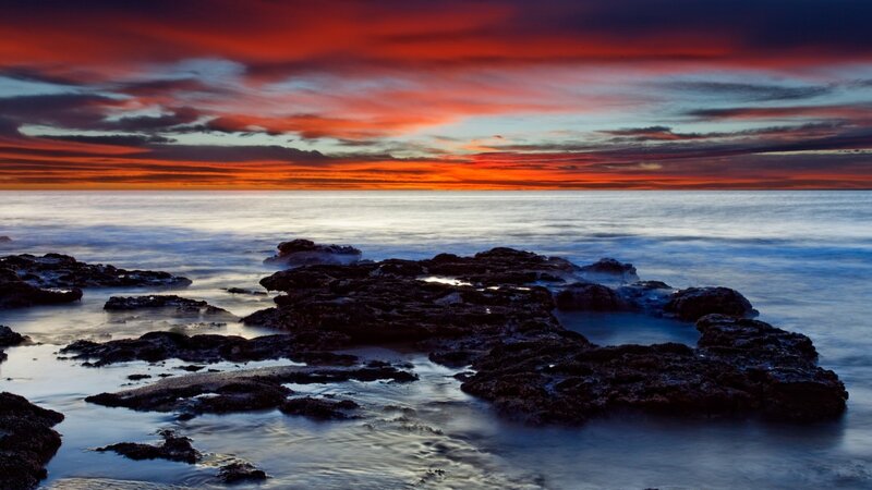 Vibrant sunset over rocky shore