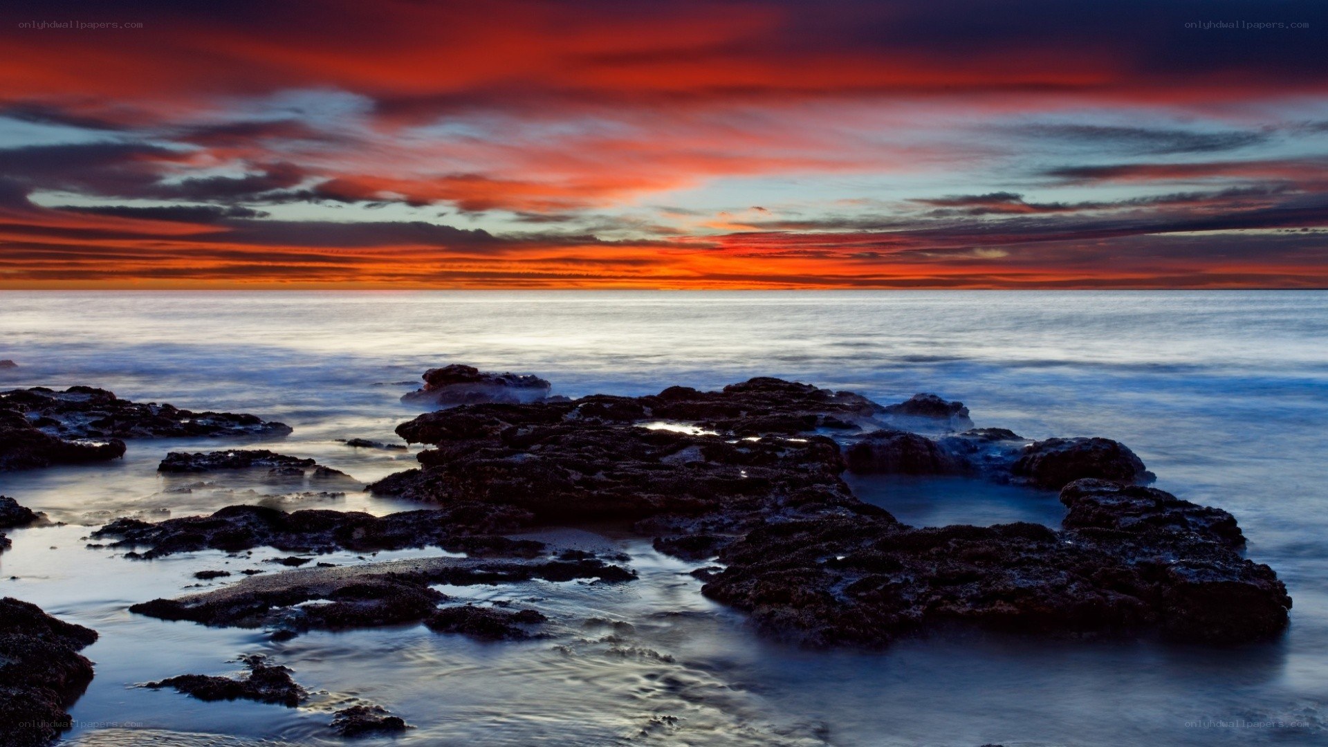 Vibrant sunset over rocky shore