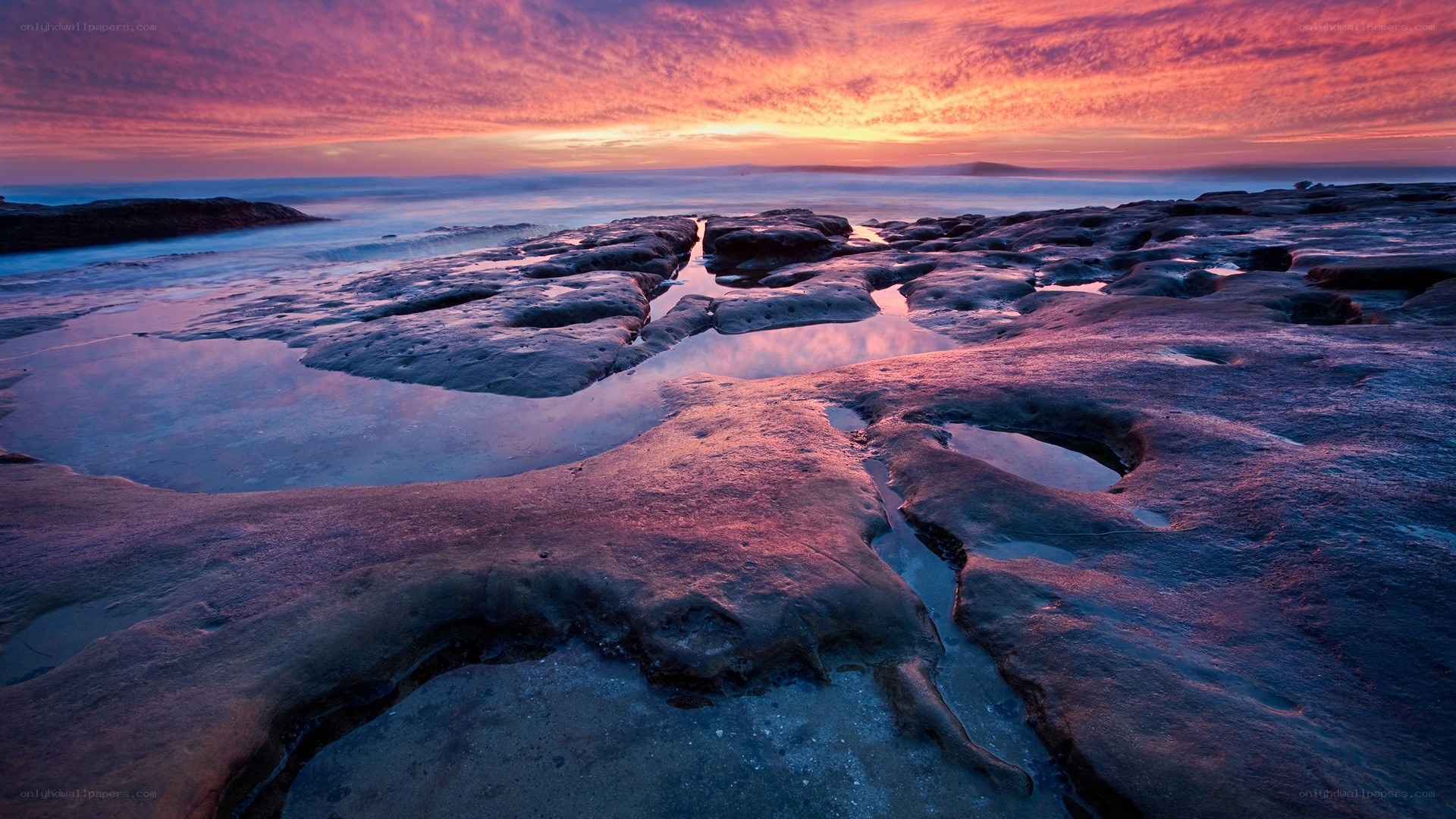 Vibrant sunset over rocky shore
