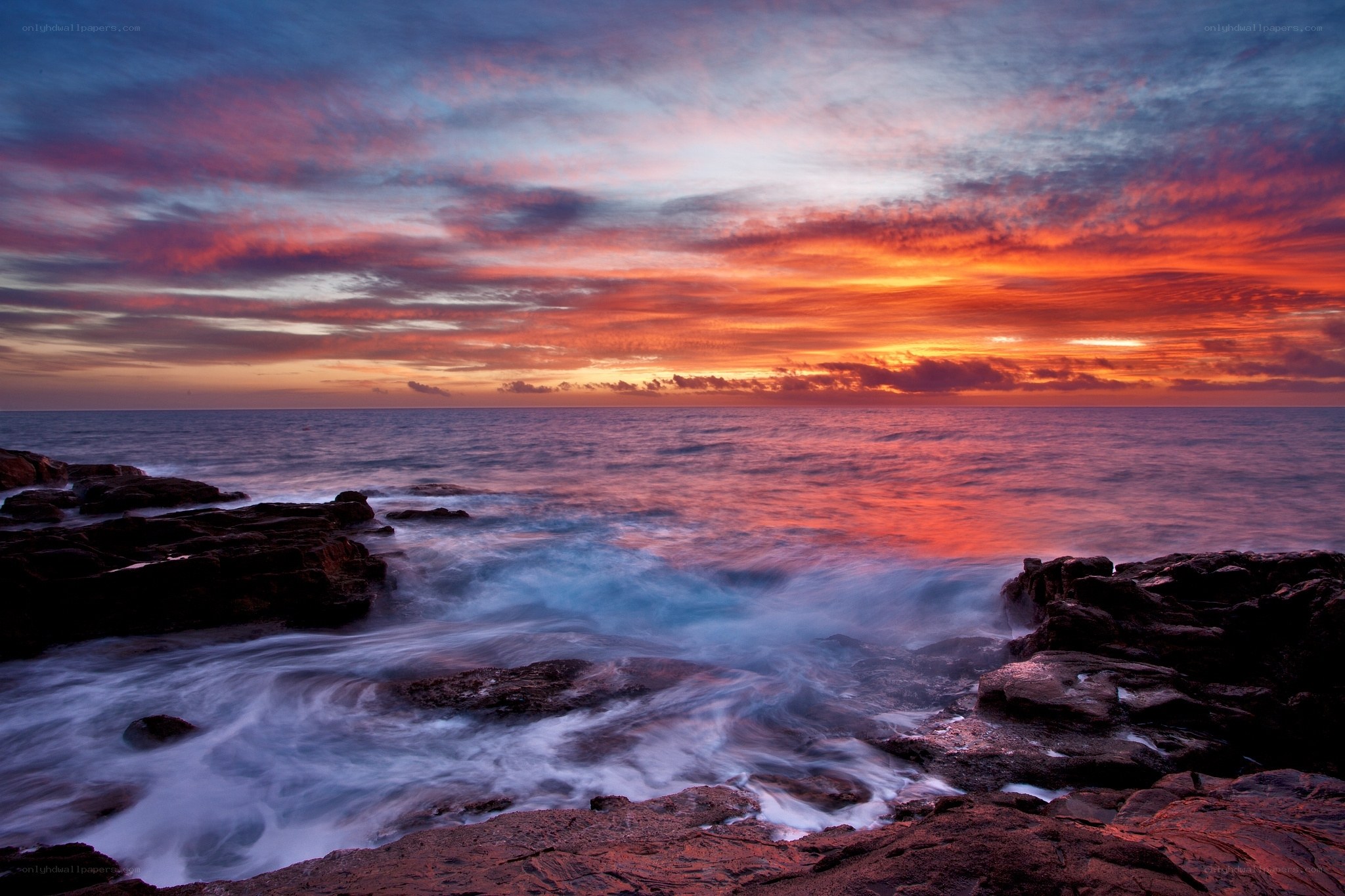 Vibrant sunset over rocky shore