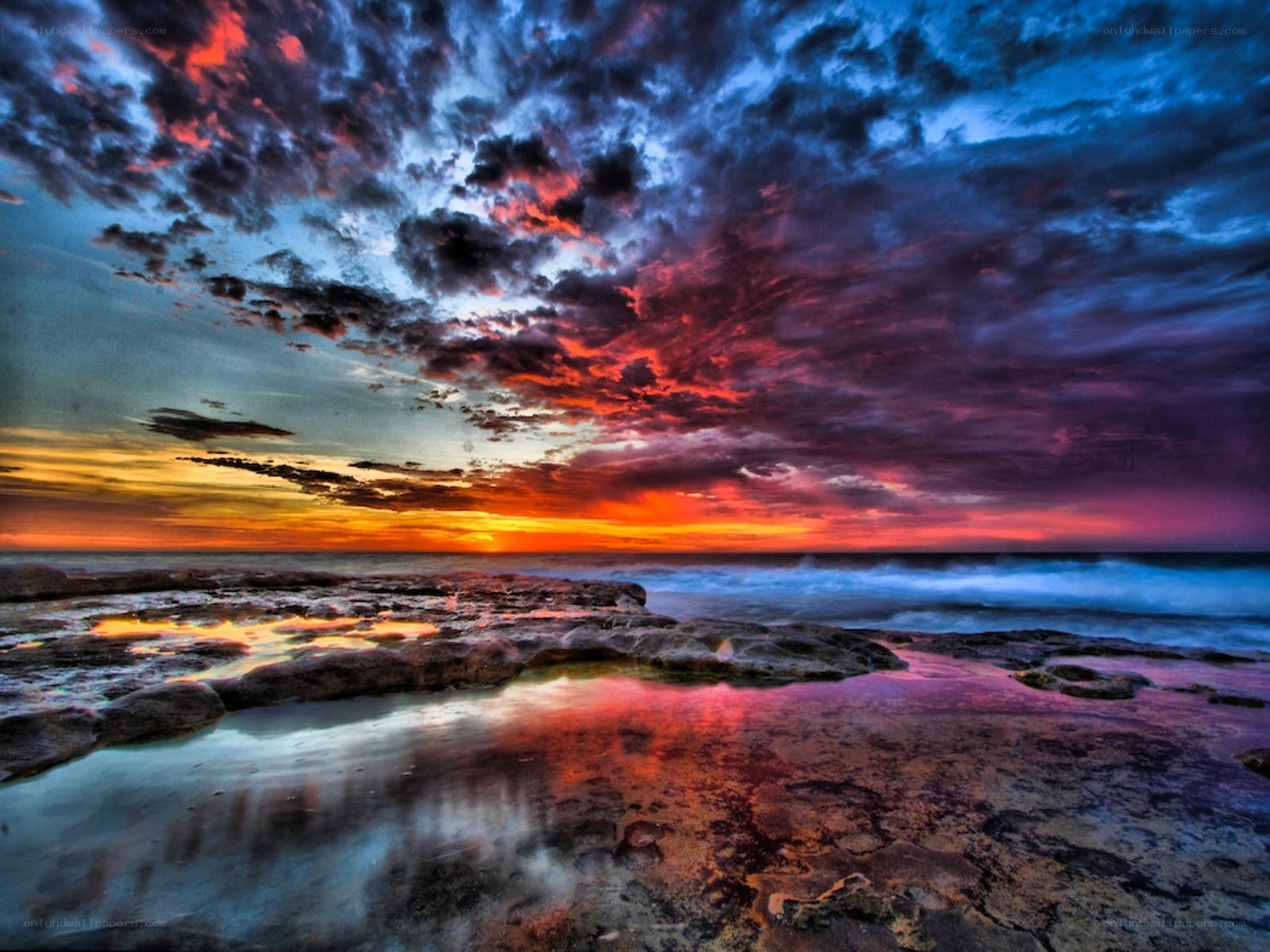 Vibrant sunset over rocky shore