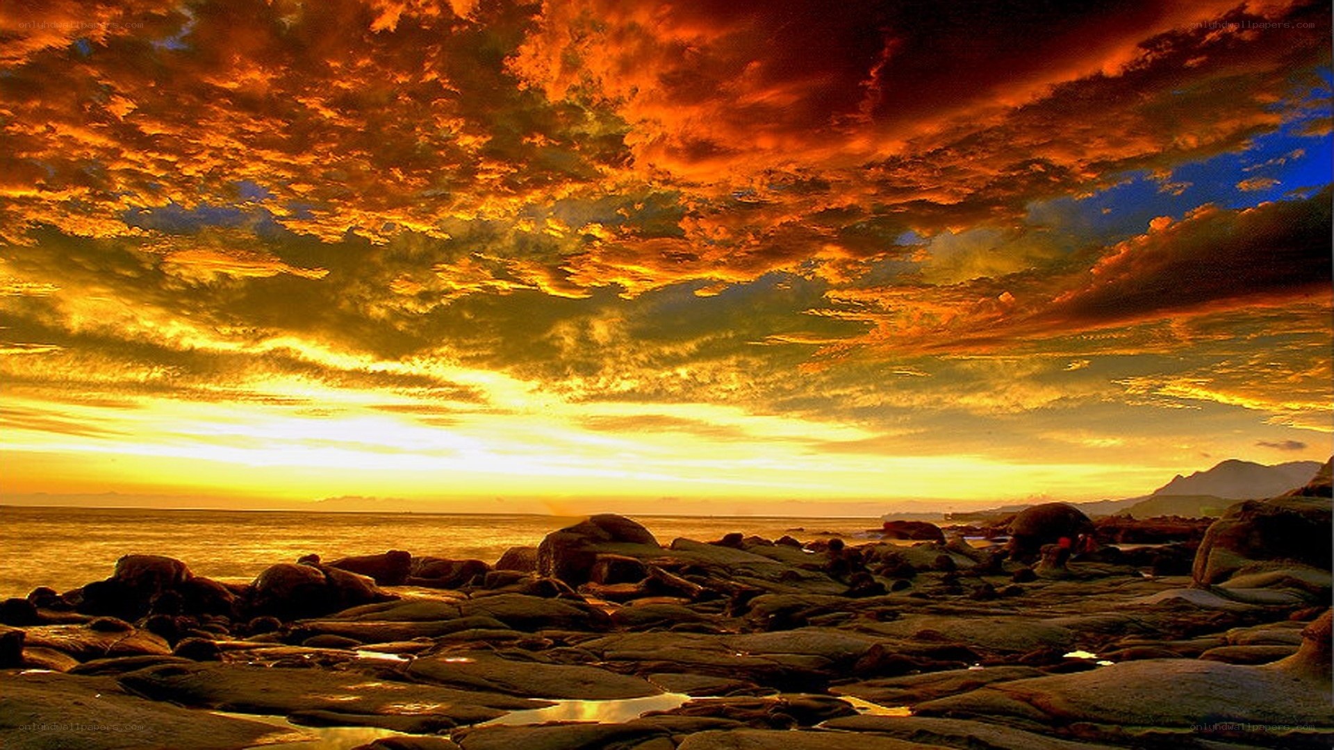 Vibrant sunset over rocky shore