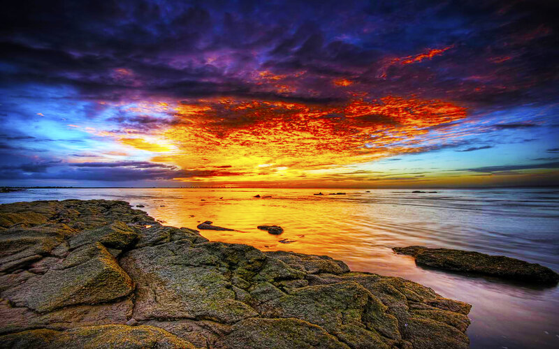 Vibrant sunset over rocky shore