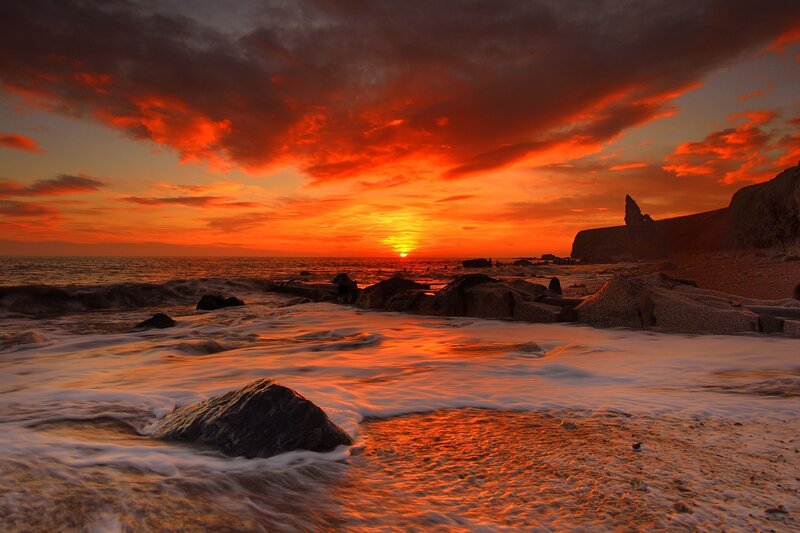 Vibrant sunset over rocky shore