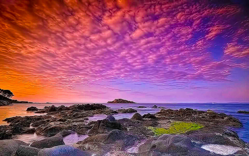 Vibrant sunset over rocky shore
