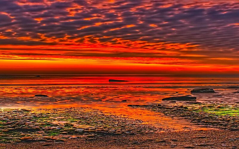 Vibrant sunset over rocky shore