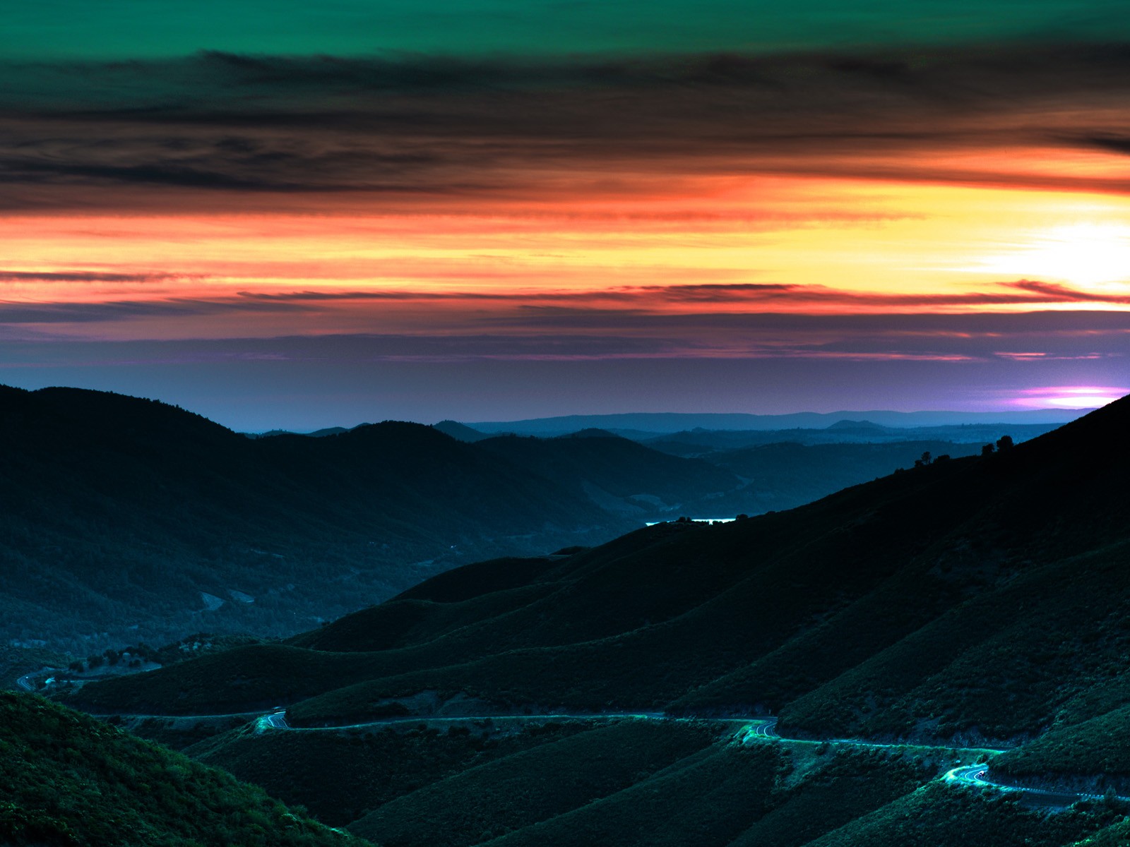 Vibrant sunset over rolling hills