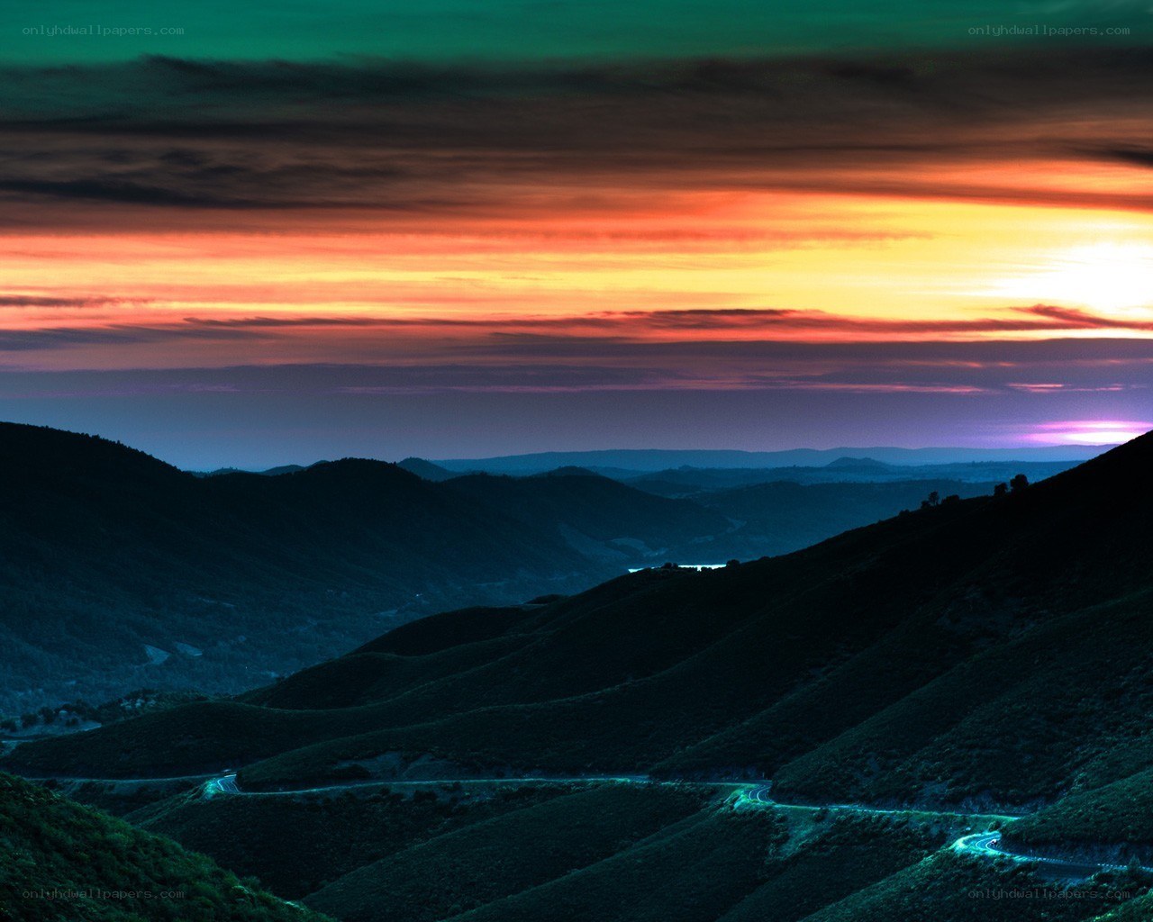 Vibrant sunset over rolling hills